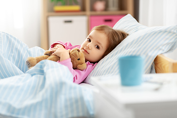 Image showing sick little girl lying in bed at home