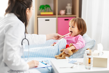 Image showing doctor checking sick girl's throat at home