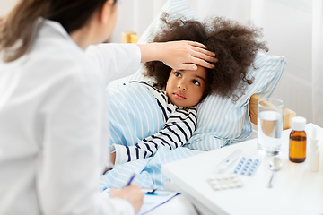 Image showing doctor with clipboard and sick girl in bed at home