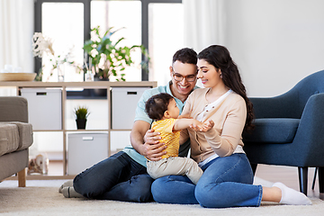 Image showing happy family with child sitting on floor at home