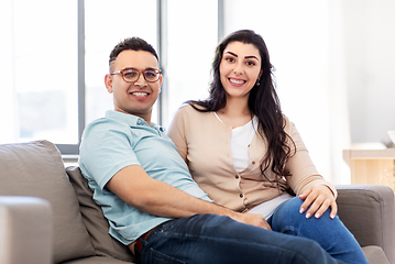 Image showing happy couple sitting on sofa at home