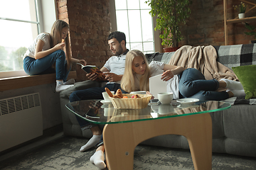 Image showing Mother, father and daughter at home having fun, comfort and cozy concept