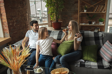 Image showing Mother, father and daughter at home having fun, comfort and cozy concept