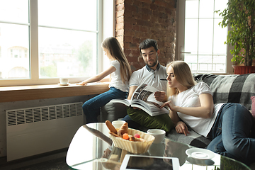 Image showing Mother, father and daughter at home having fun, comfort and cozy concept