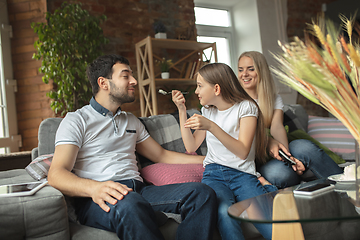 Image showing Mother, father and daughter at home having fun, comfort and cozy concept