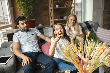 Image showing Mother, father and daughter at home having fun, comfort and cozy concept