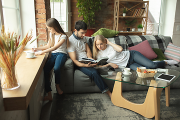 Image showing Mother, father and daughter at home having fun, comfort and cozy concept