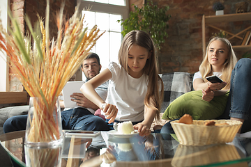 Image showing Mother, father and daughter at home having fun, comfort and cozy concept