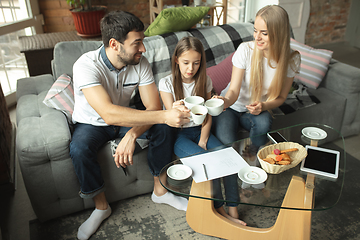 Image showing Mother, father and daughter at home having fun, comfort and cozy concept