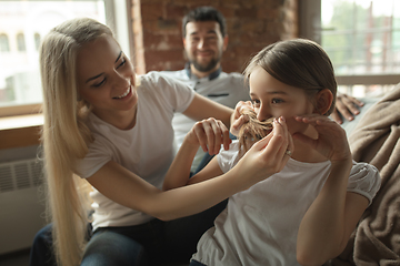 Image showing Mother, father and daughter at home having fun, comfort and cozy concept