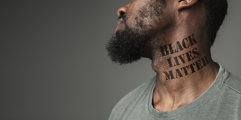 Image showing Close up portrait of a black man tired of racial discrimination has tattooed slogan on his neck