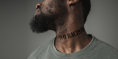 Image showing Close up portrait of a black man tired of racial discrimination has tattooed slogan on his neck