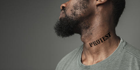 Image showing Close up portrait of a black man tired of racial discrimination has tattooed slogan on his neck