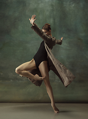 Image showing Young graceful tender ballerina on dark studio background