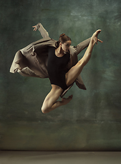 Image showing Young graceful tender ballerina on dark studio background