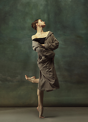 Image showing Young graceful tender ballerina on dark studio background