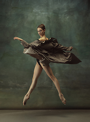 Image showing Young graceful tender ballerina on dark studio background