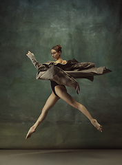 Image showing Young graceful tender ballerina on dark studio background