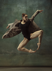 Image showing Young graceful tender ballerina on dark studio background