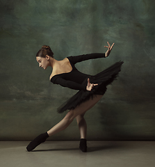 Image showing Young graceful tender ballerina on dark studio background