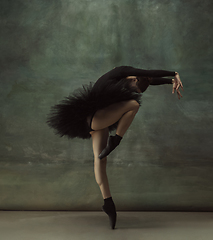 Image showing Young graceful tender ballerina on dark studio background