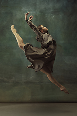 Image showing Young graceful tender ballerina on dark studio background