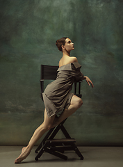 Image showing Young graceful tender ballerina on dark studio background