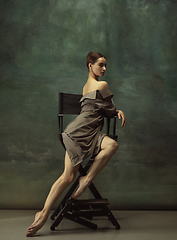 Image showing Young graceful tender ballerina on dark studio background