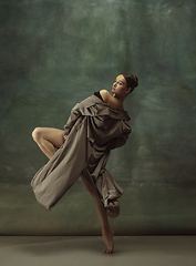 Image showing Young graceful tender ballerina on dark studio background