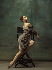 Image showing Young graceful tender ballerina on dark studio background