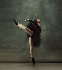 Image showing Young graceful tender ballerina on dark studio background