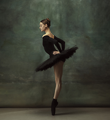 Image showing Young graceful tender ballerina on dark studio background