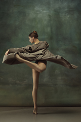 Image showing Young graceful tender ballerina on dark studio background