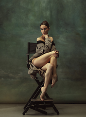 Image showing Young graceful tender ballerina on dark studio background