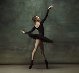 Image showing Young graceful tender ballerina on dark studio background