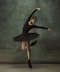 Image showing Young graceful tender ballerina on dark studio background