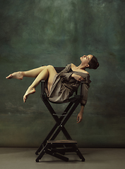 Image showing Young graceful tender ballerina on dark studio background