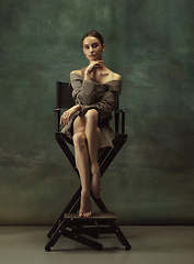 Image showing Young graceful tender ballerina on dark studio background