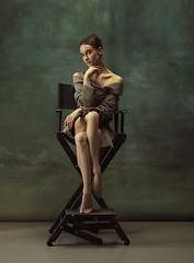 Image showing Young graceful tender ballerina on dark studio background