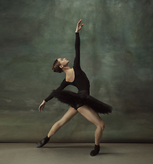 Image showing Young graceful tender ballerina on dark studio background