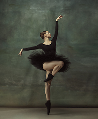 Image showing Young graceful tender ballerina on dark studio background