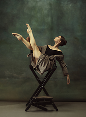 Image showing Young graceful tender ballerina on dark studio background