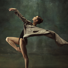 Image showing Young graceful tender ballerina on dark studio background