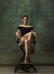 Image showing Young graceful tender ballerina on dark studio background