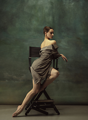 Image showing Young graceful tender ballerina on dark studio background