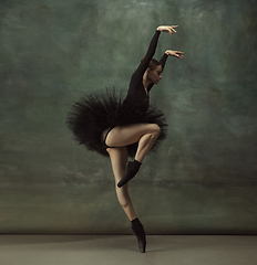 Image showing Young graceful tender ballerina on dark studio background