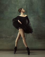 Image showing Young graceful tender ballerina on dark studio background