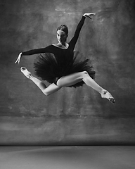 Image showing Young graceful tender ballerina on dark studio background