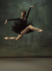 Image showing Young graceful tender ballerina on dark studio background