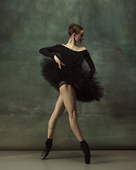 Image showing Young graceful tender ballerina on dark studio background